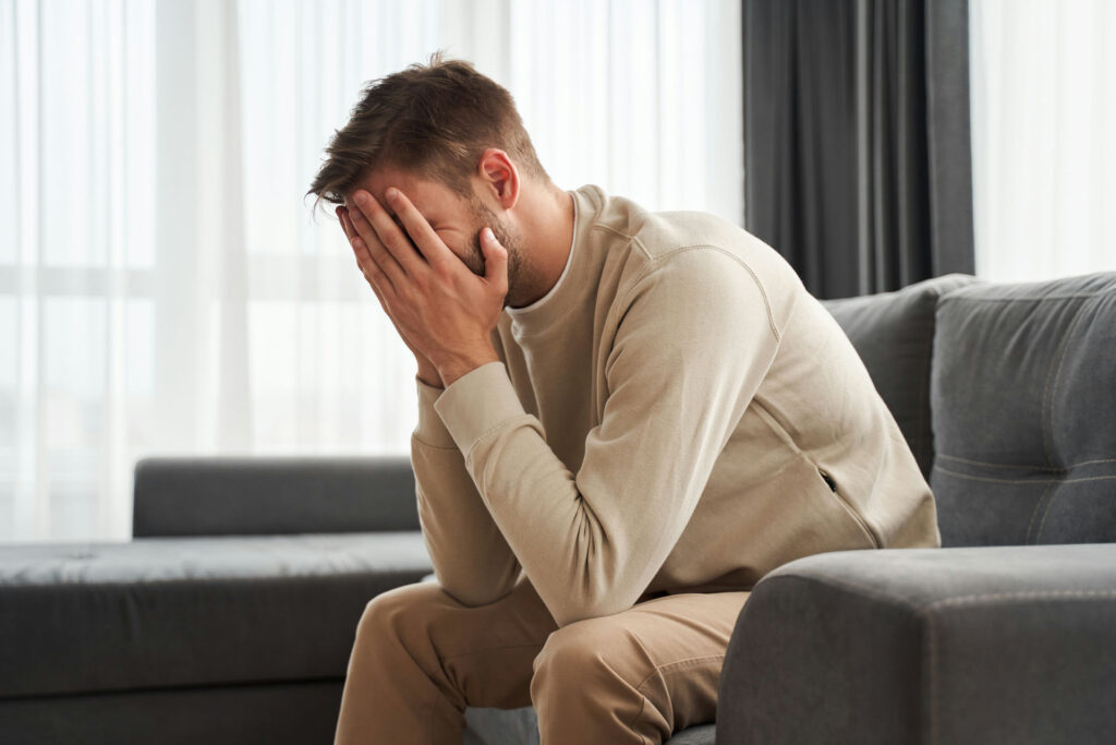 a-man-with-anxiety-covering-face