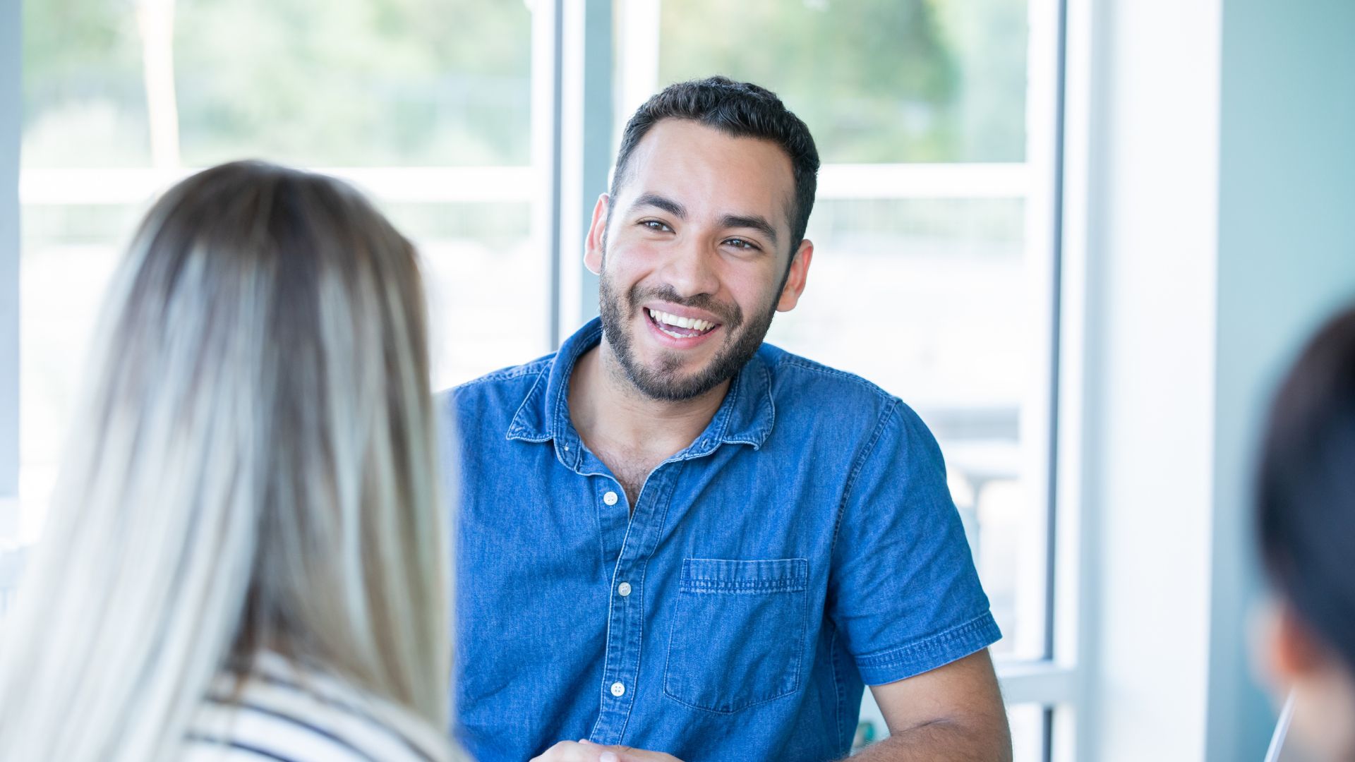 Mental Health Disorder Treatment Smiling man in a blue shirt feeling hopeful during mental health disorder treatment