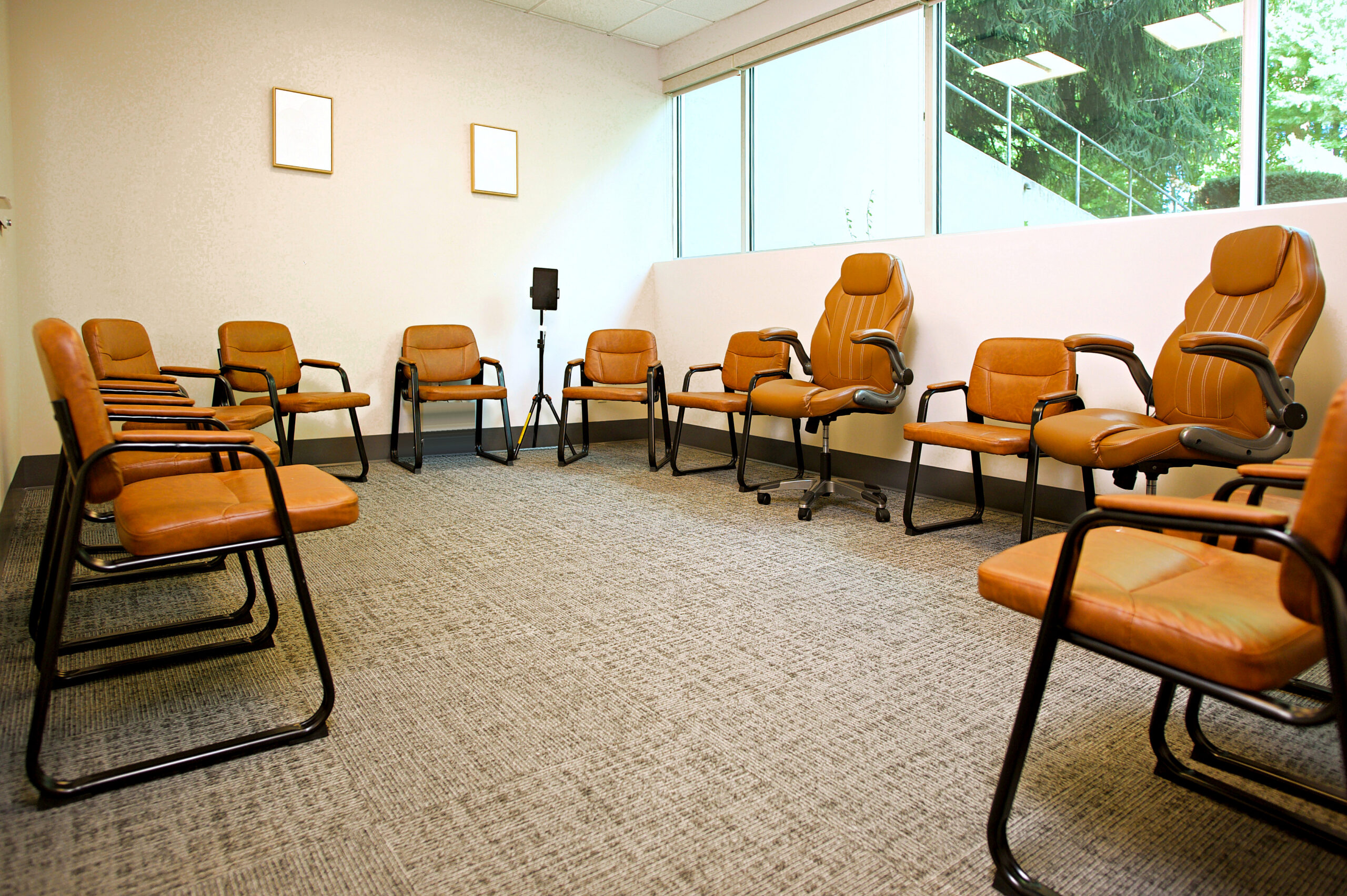 Group therapy room at Holgate Mental Health with chairs arranged in a circle and large windows